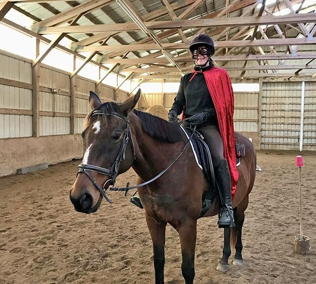 bay horse with star and stripe with rider dressed up for Halloween gymkhana