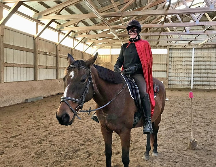 bay horse with star and stripe with rider dressed up for Halloween gymkhana